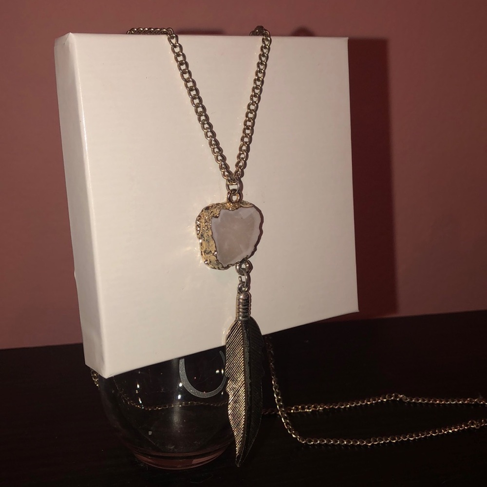 Long necklace with pink stone and feather pendant